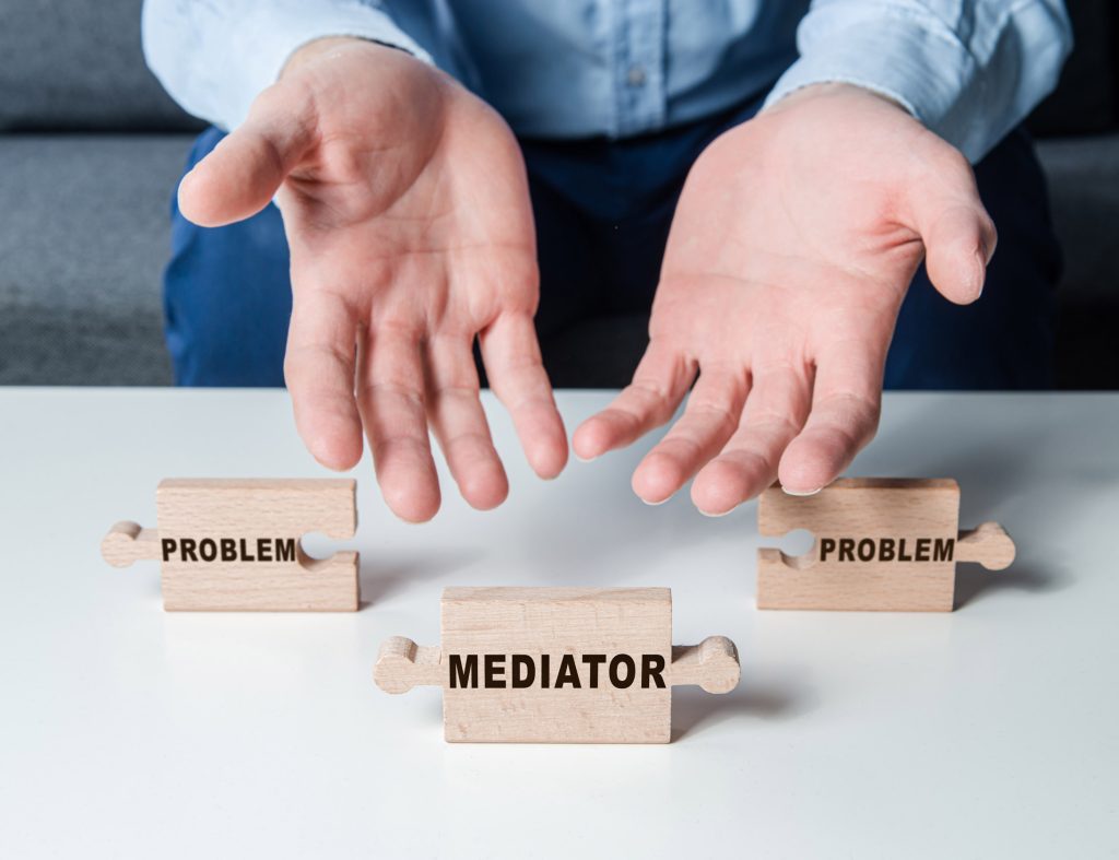 Hands pointing to mediator jigsaw piece – Painter and Decorator mediation